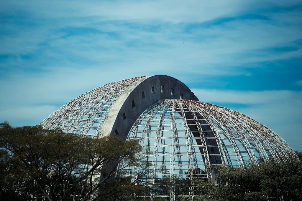 pexels photo 12479951 12479951 A stunning modern glass dome in a botanical garden against a clear sky.